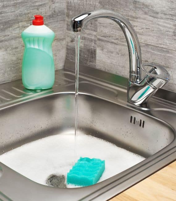 Filling up the sink and then adding clothes is fundamental to properly knowing how to wash laundry by hand.