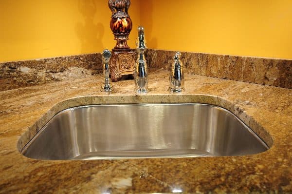 Using soap and a microfiber cloth is one way of how to clean granite countertops.