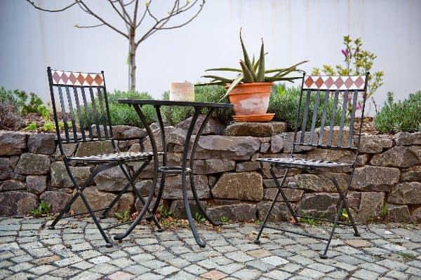 How to clean patio furniture: clean wrought iron regularly to avoid rust buildup.